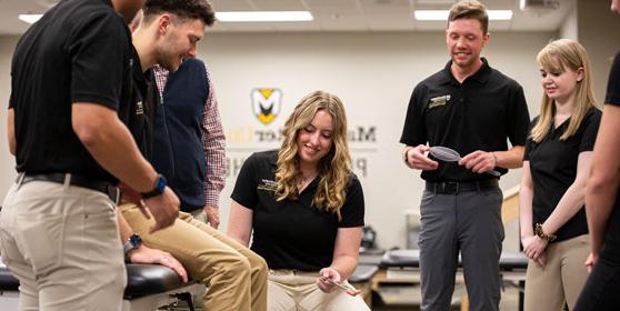 Inside the DPT lab at MU students take turns practicing a new skill